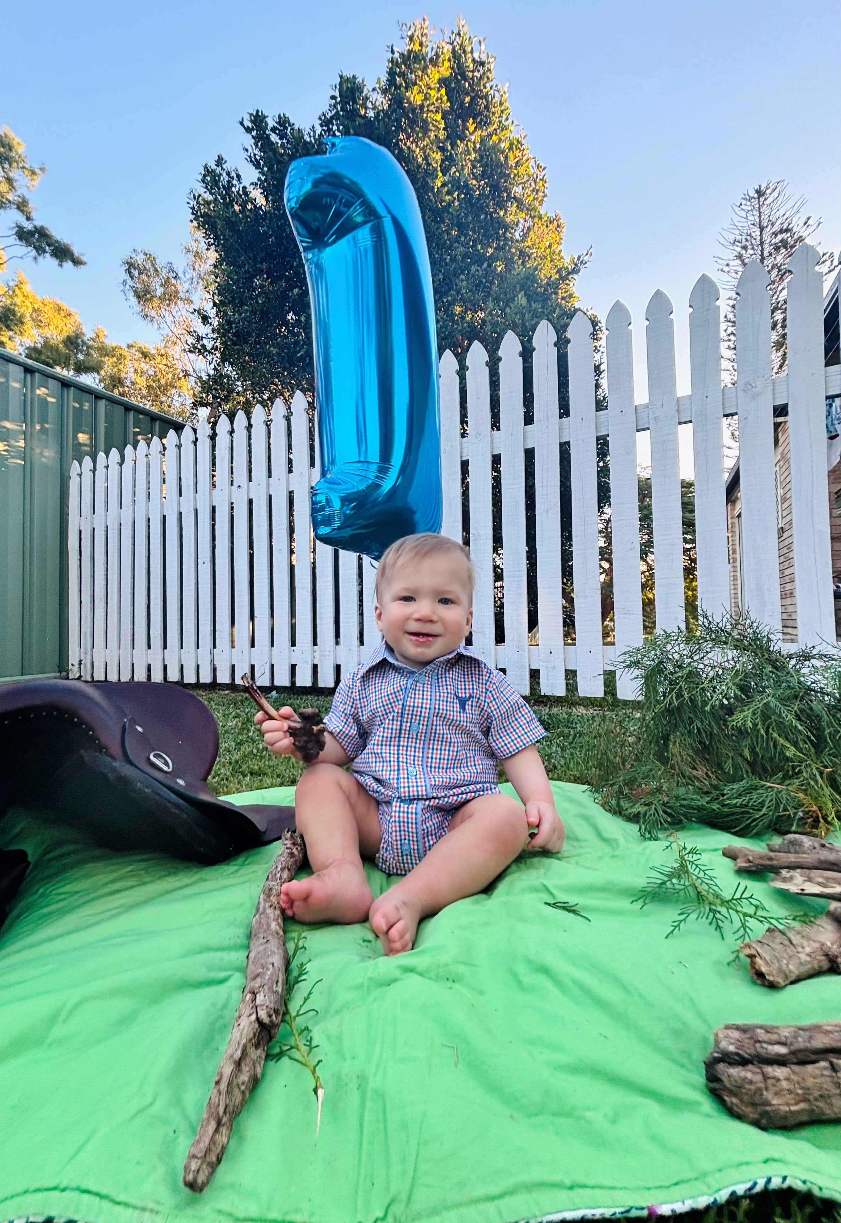 Luxmore sits with a number 1 balloon on his birthday.