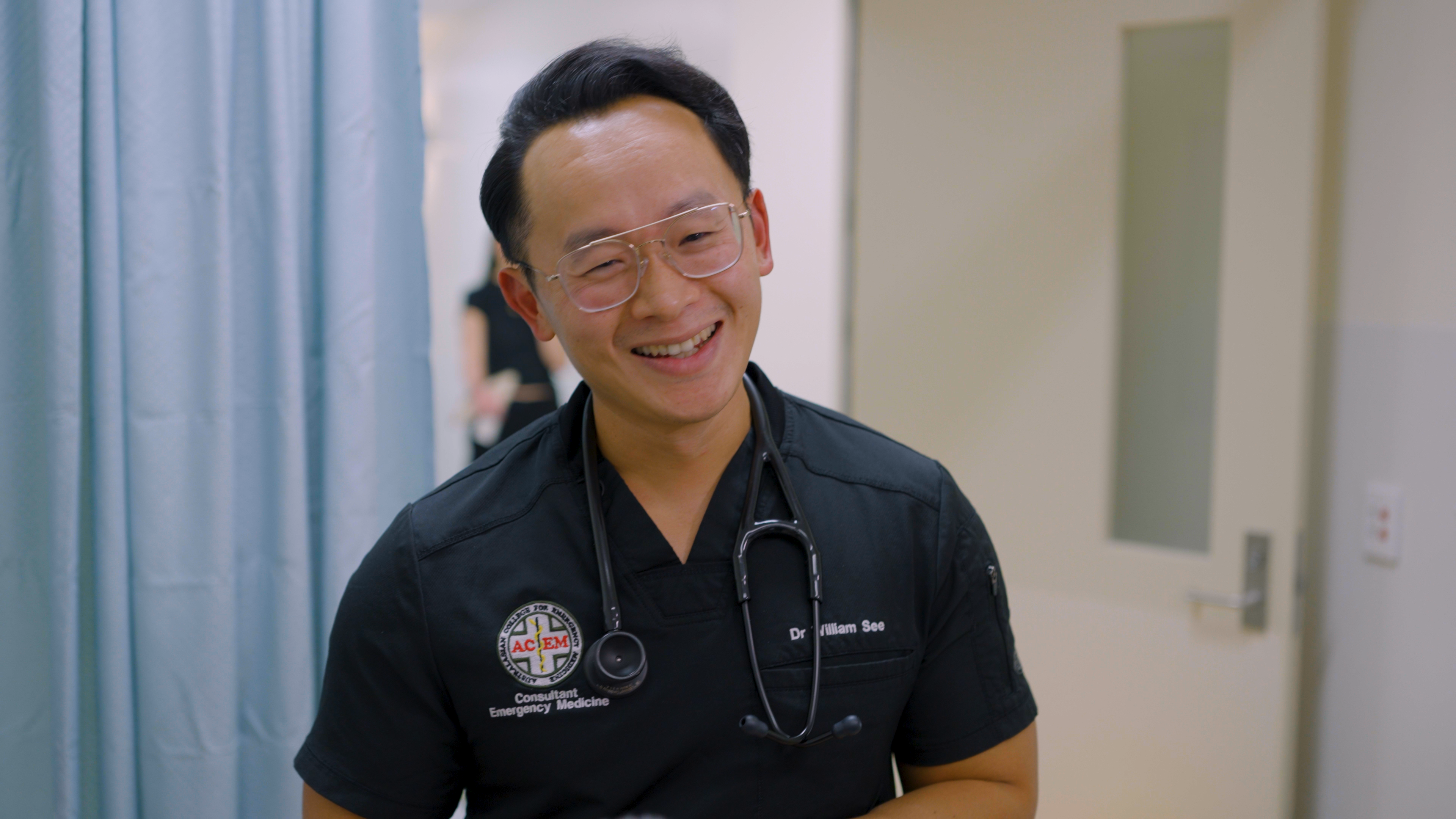 Male doctor smiles to the camera
