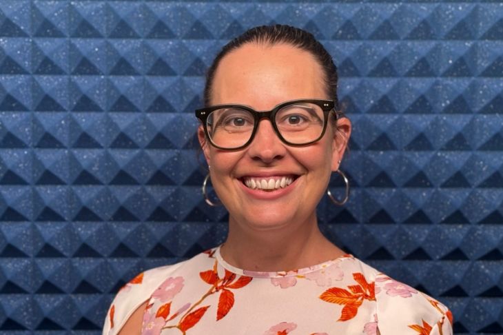 Profile photo of woman smiling and wearing glasses