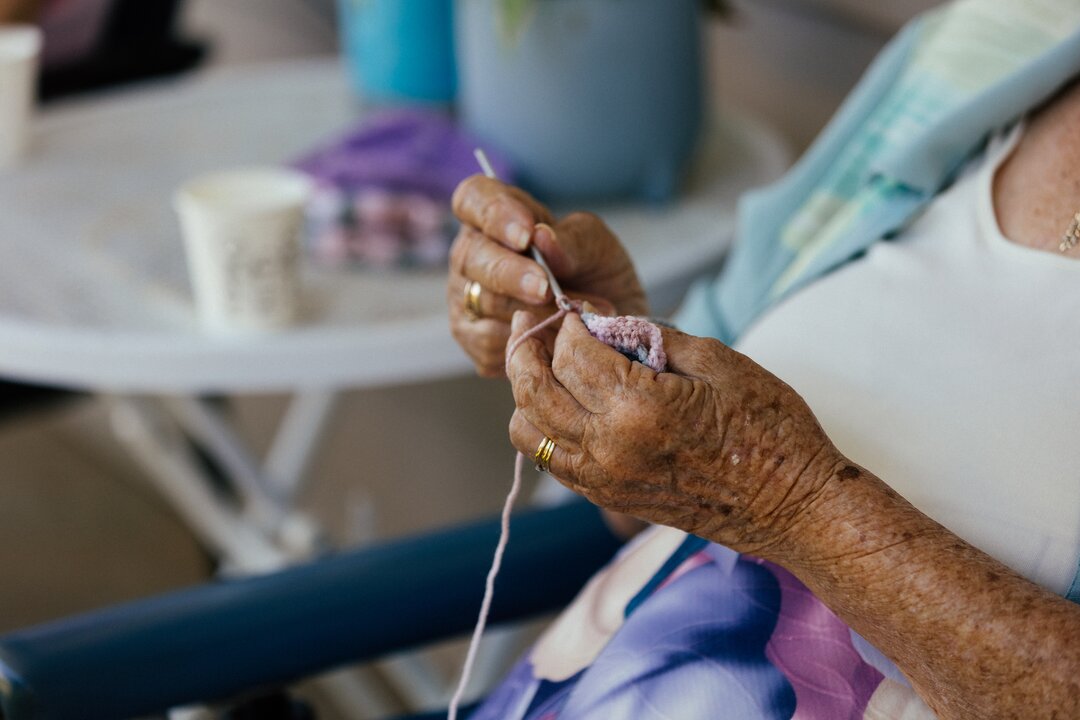 Close-up of elderly lady crocheting at Julia Creek Hospital.